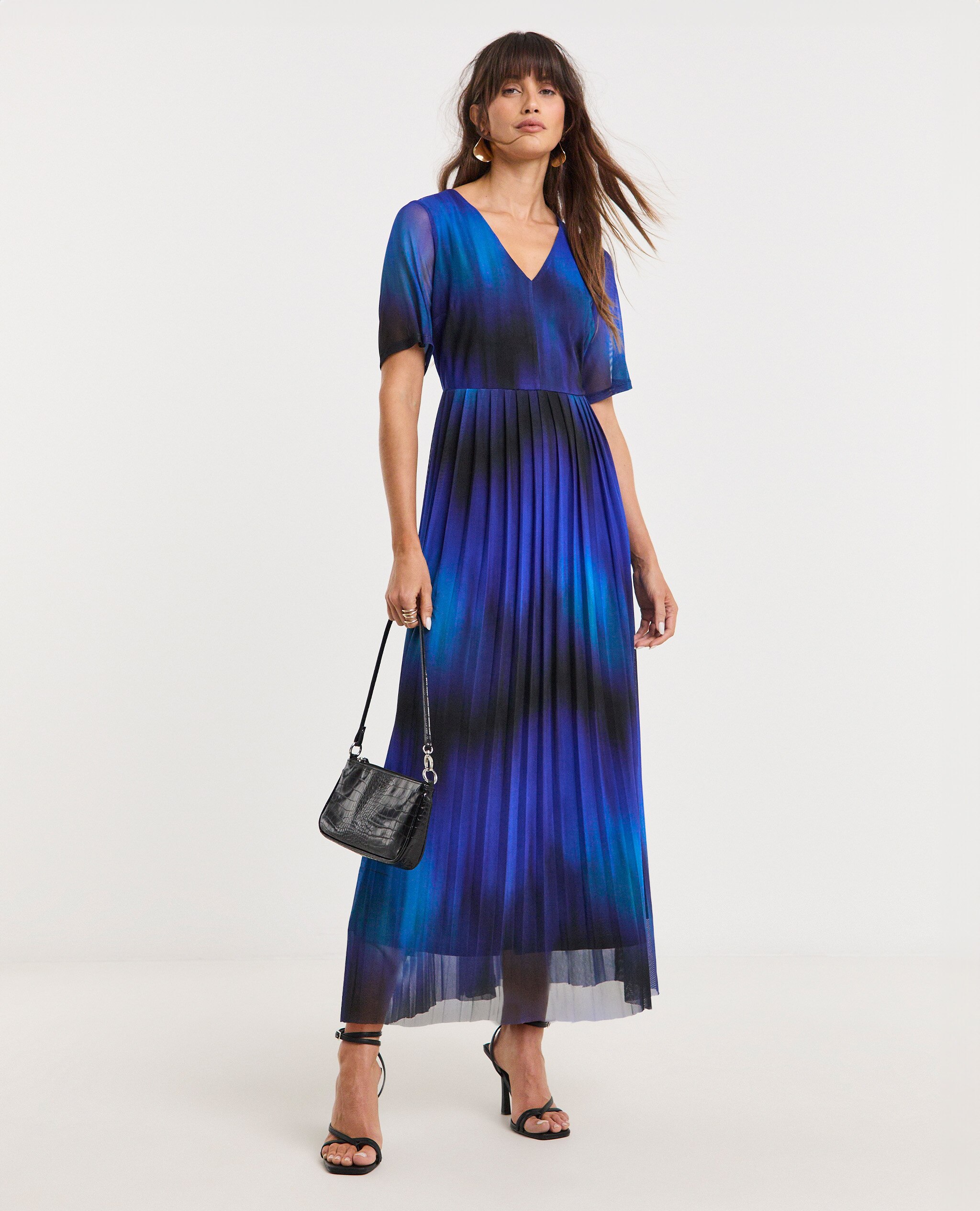 Model wearing blue and black patterned maxi dress