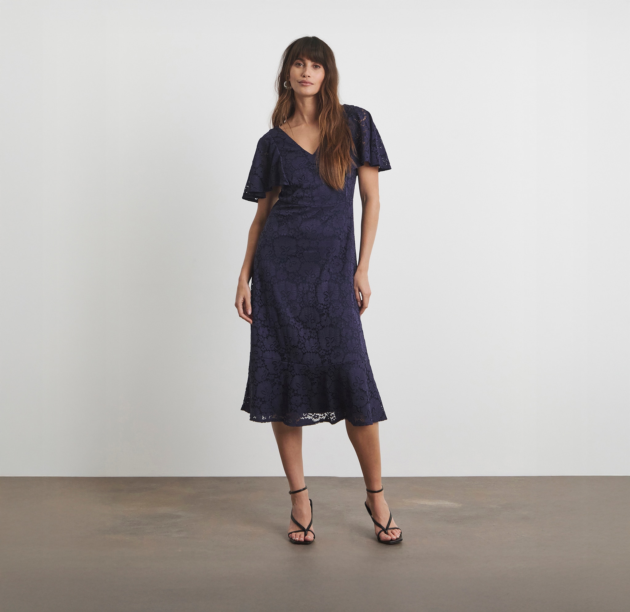 A lady wearing a navy blue embroidered patterned dress