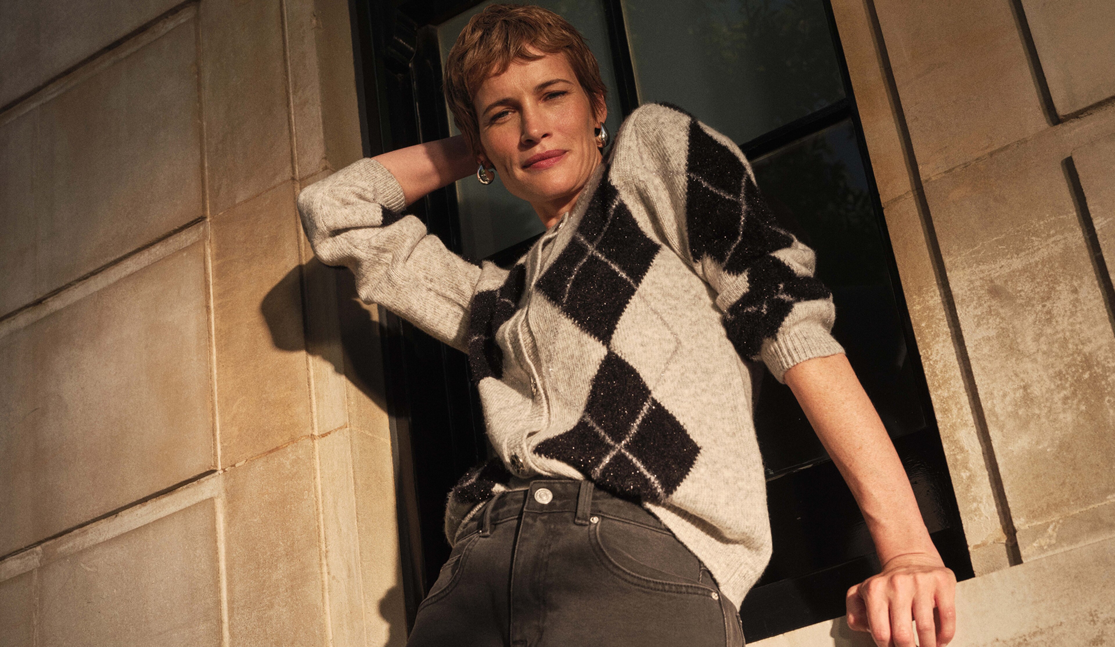 A lady wearing a black and grey fair isle cardigan
