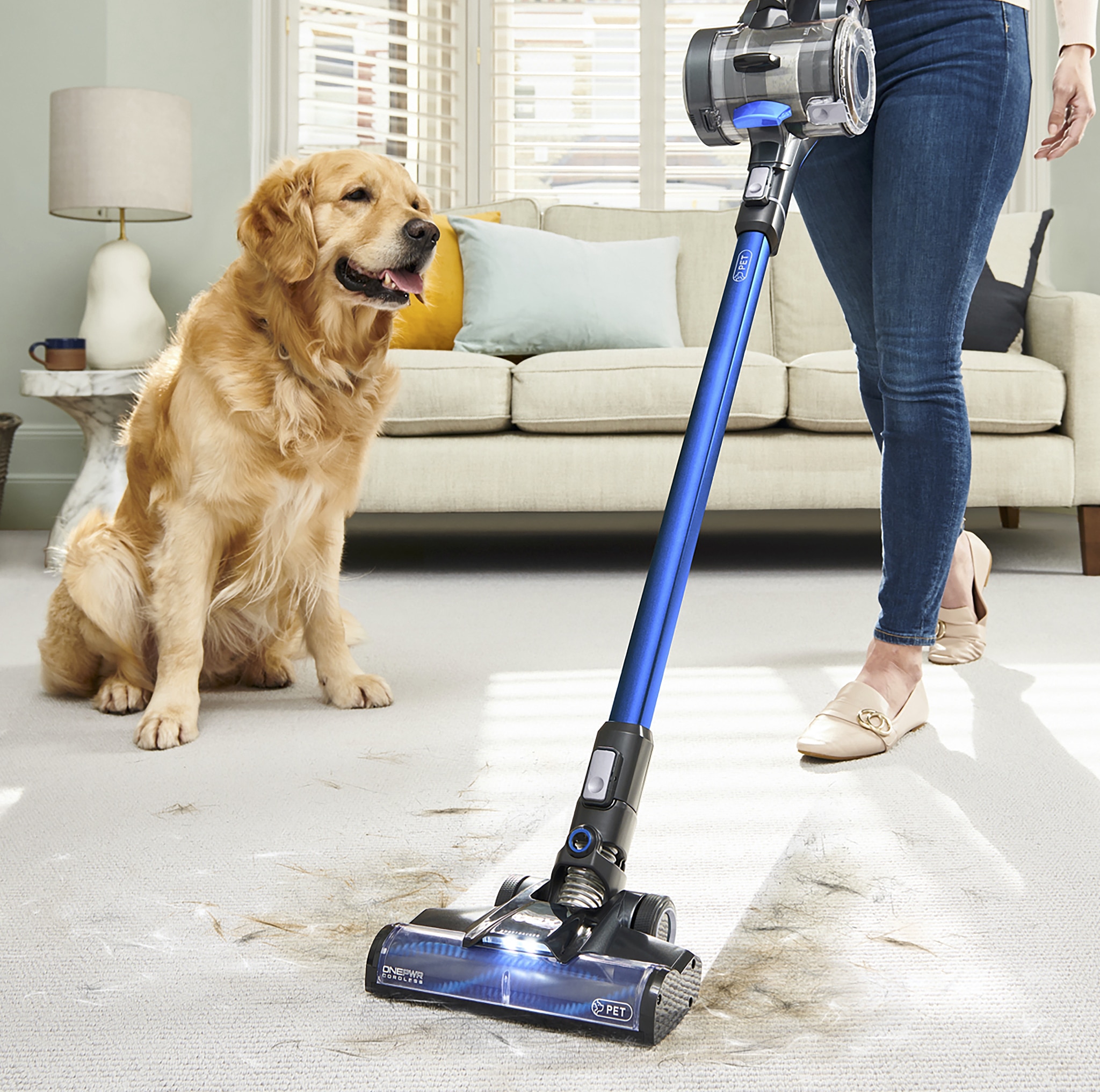 A woman using a VAX Cordless 
vacuum