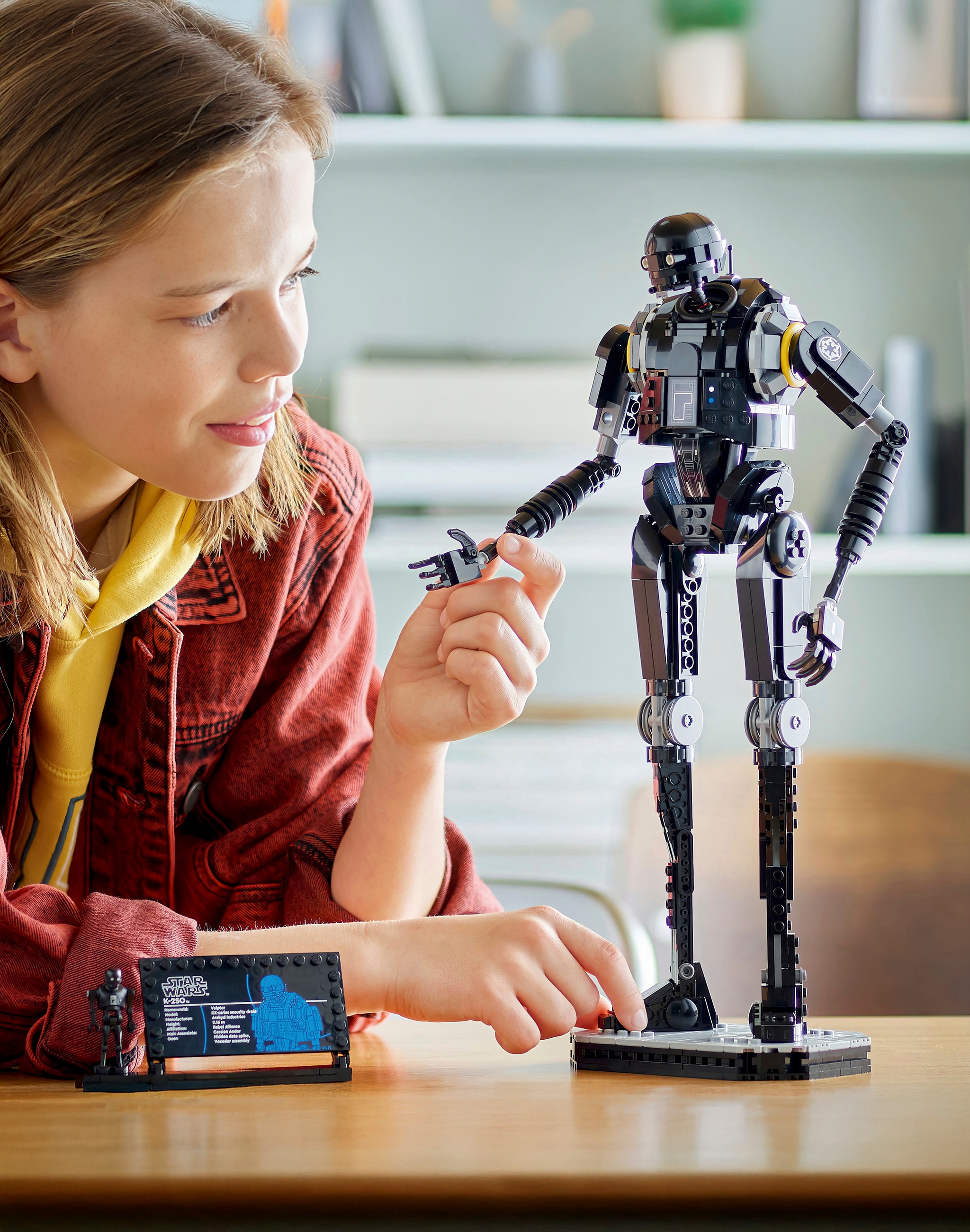 A child playing with a LEGO® Star Wars™ figure.