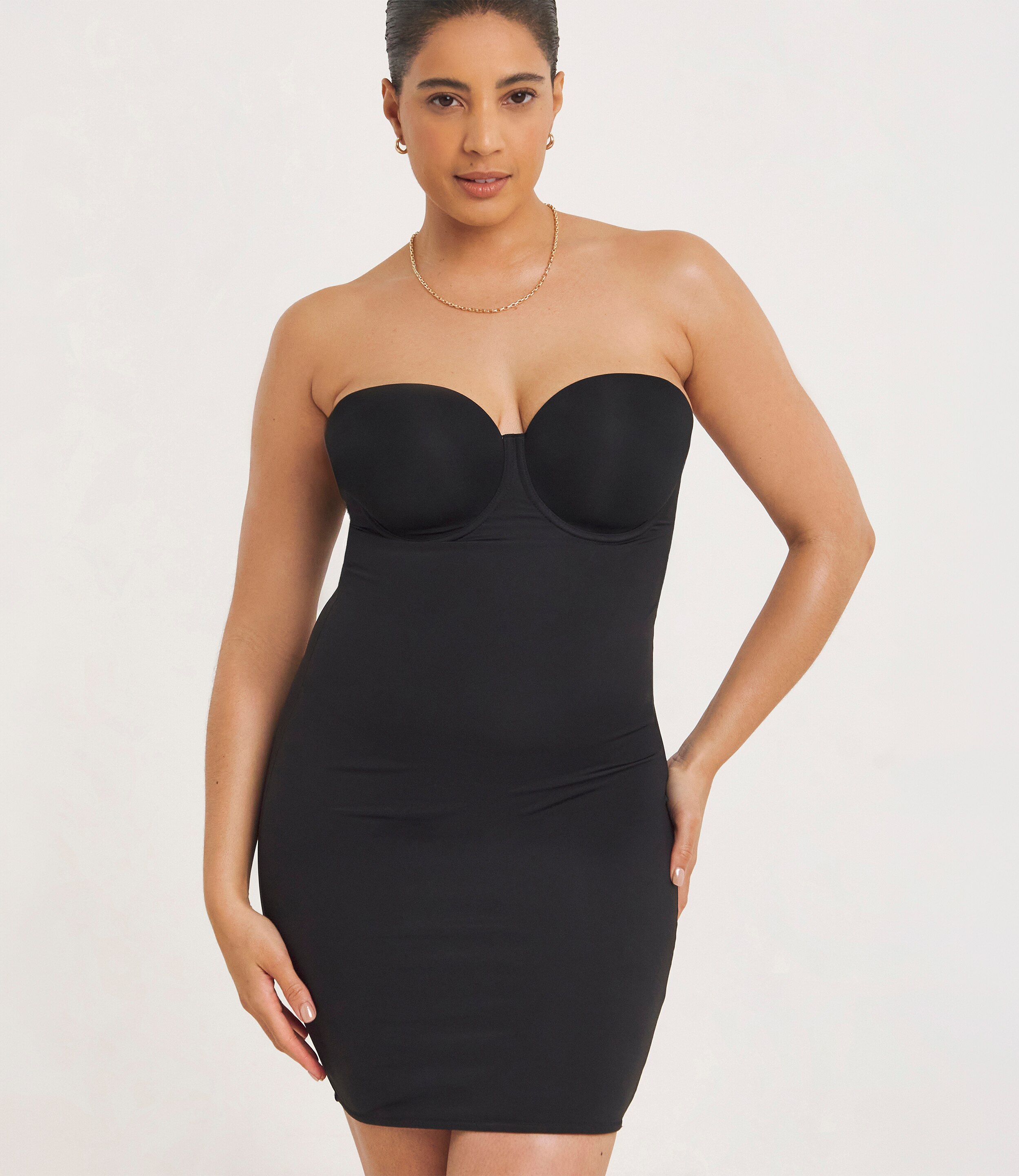A lady wearing a Figleaves Smoothing Padded Multiway Shaping Slip