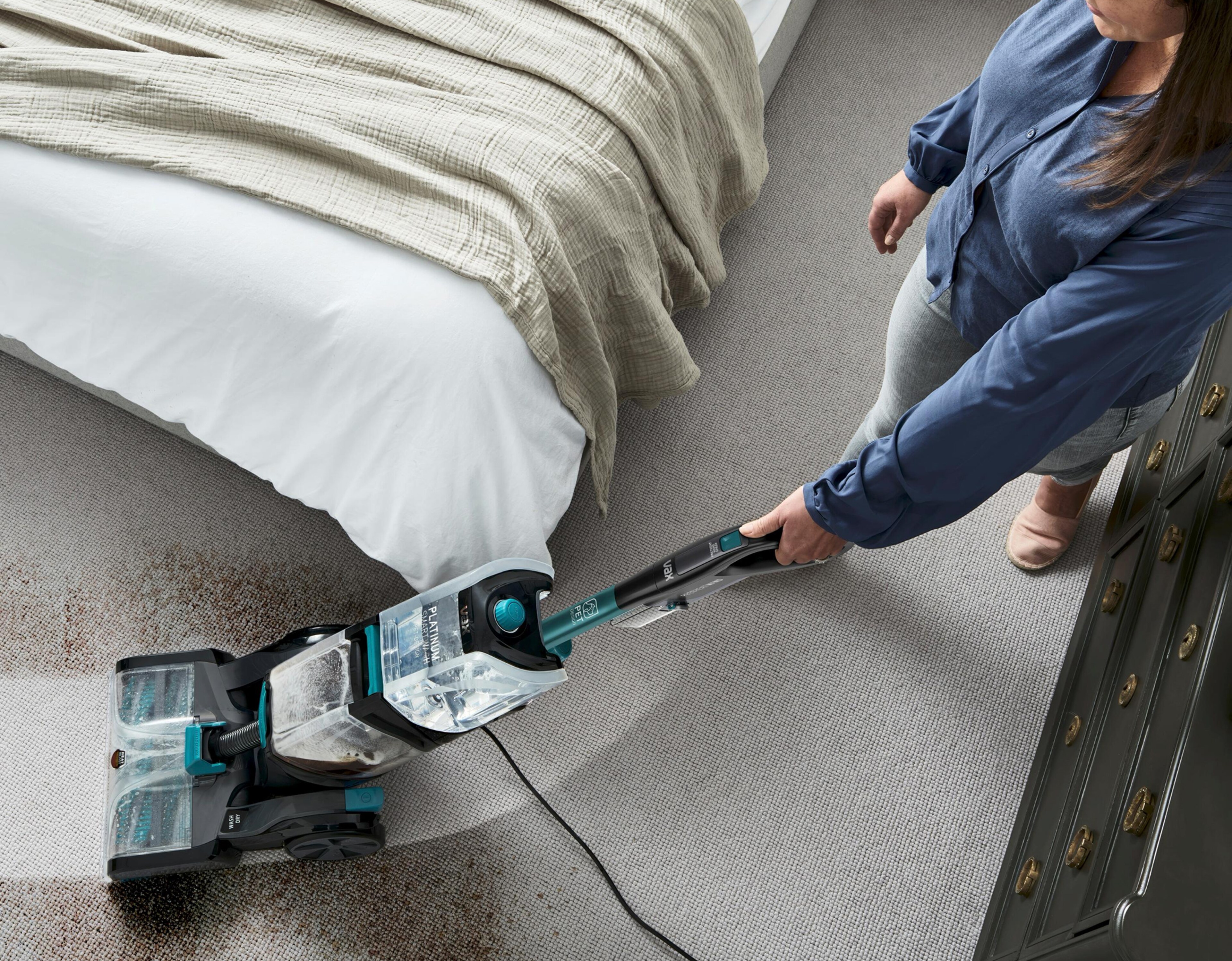 A woman using a Vax cleaner