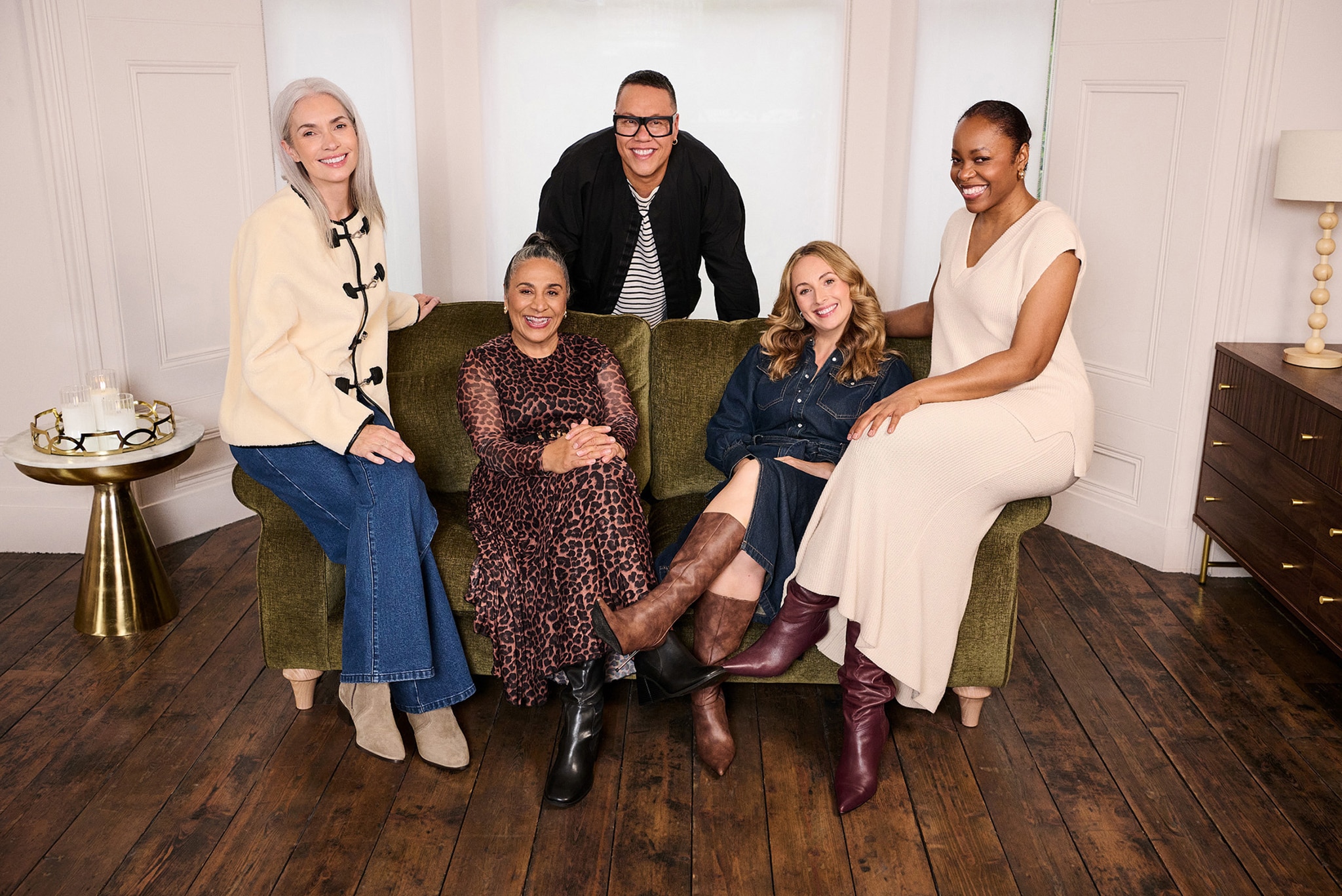 Gok Wan sat on a sofa with 4 ladies
