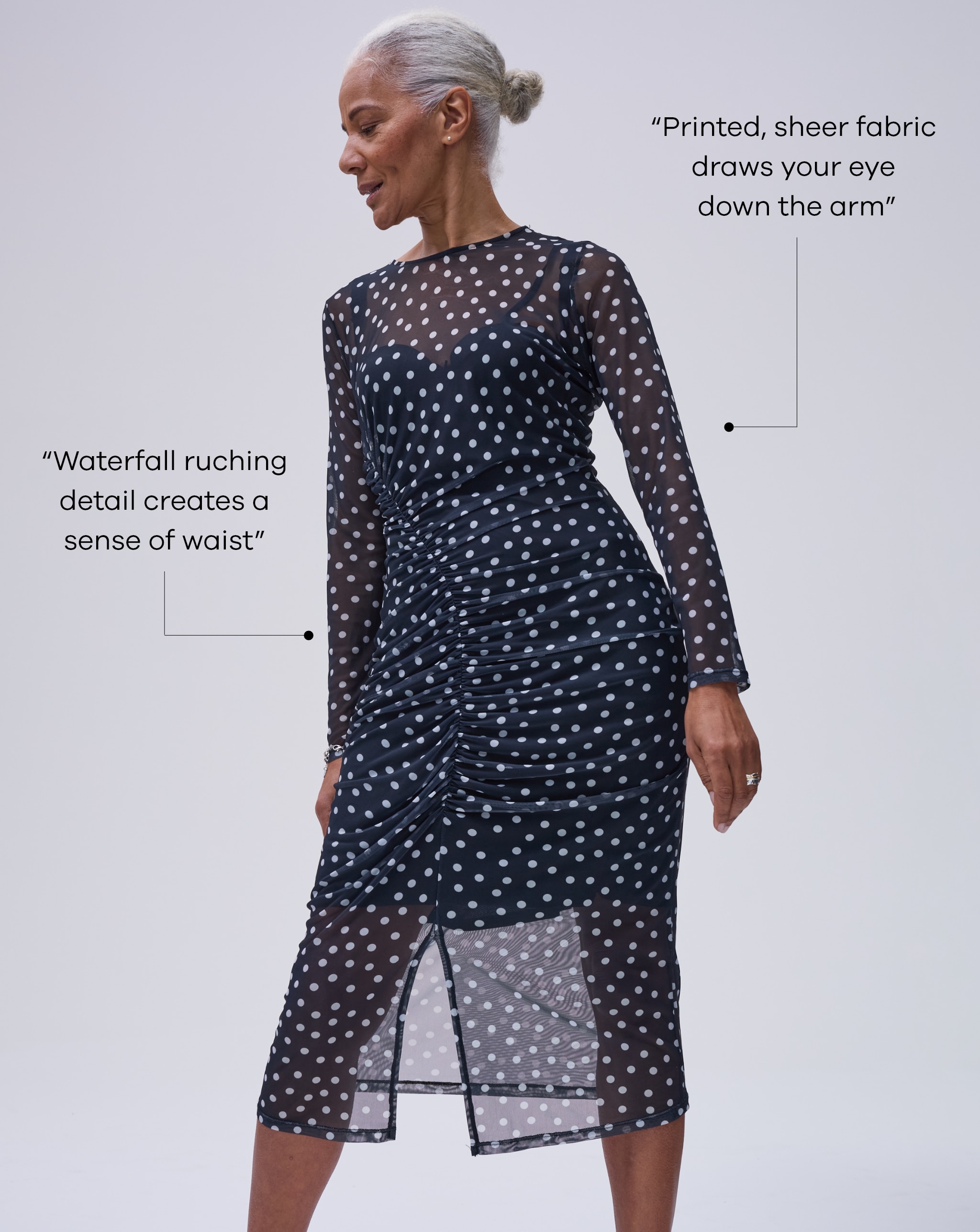 Model wearing black spotted mesh ruched midi dress. Tips highlighted - Waterfall ruching
detail creates a sense of waist. Printed, sheer fabric draws your eye down the arm