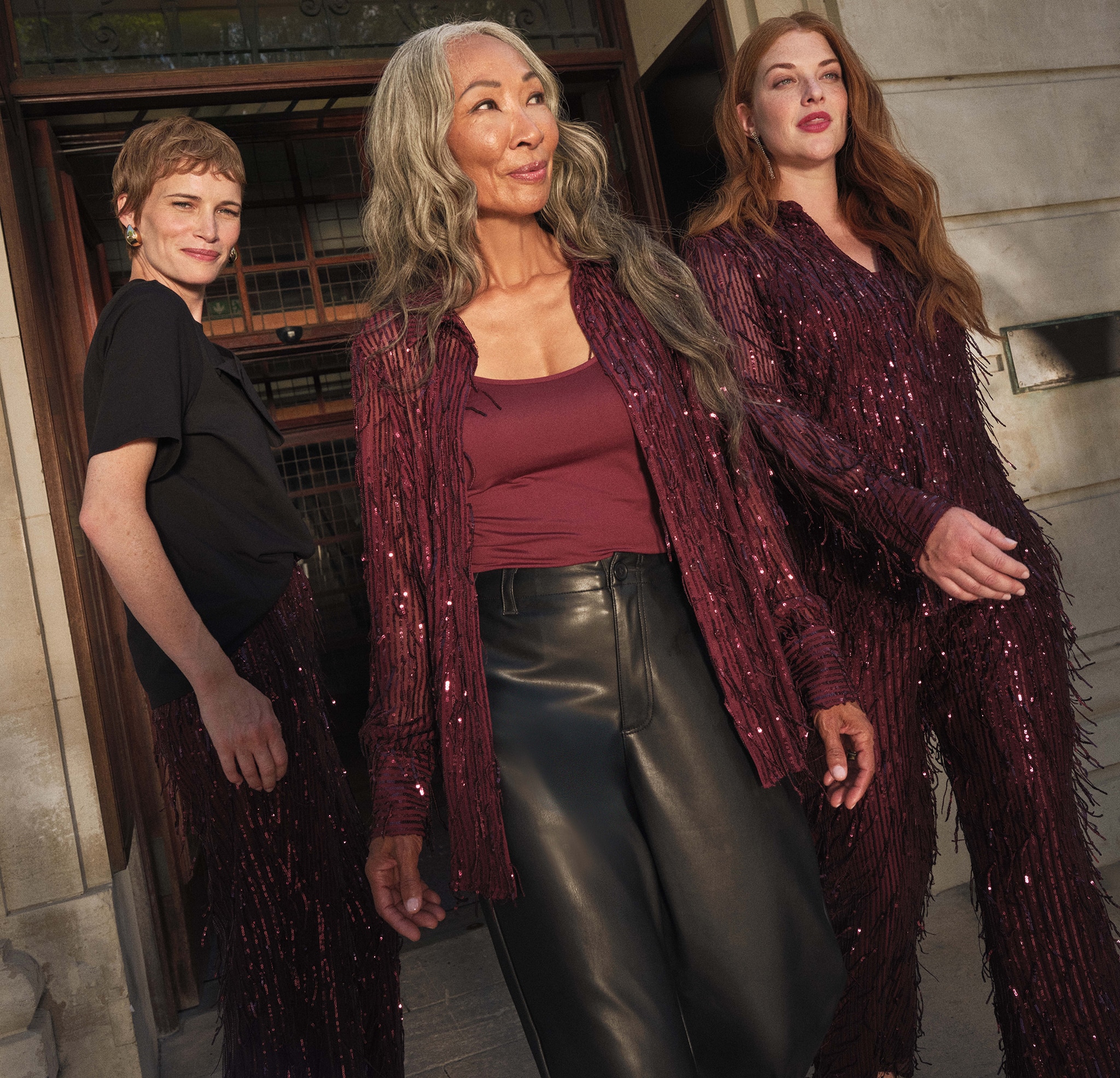 3 ladies outside a door wearing party clothes