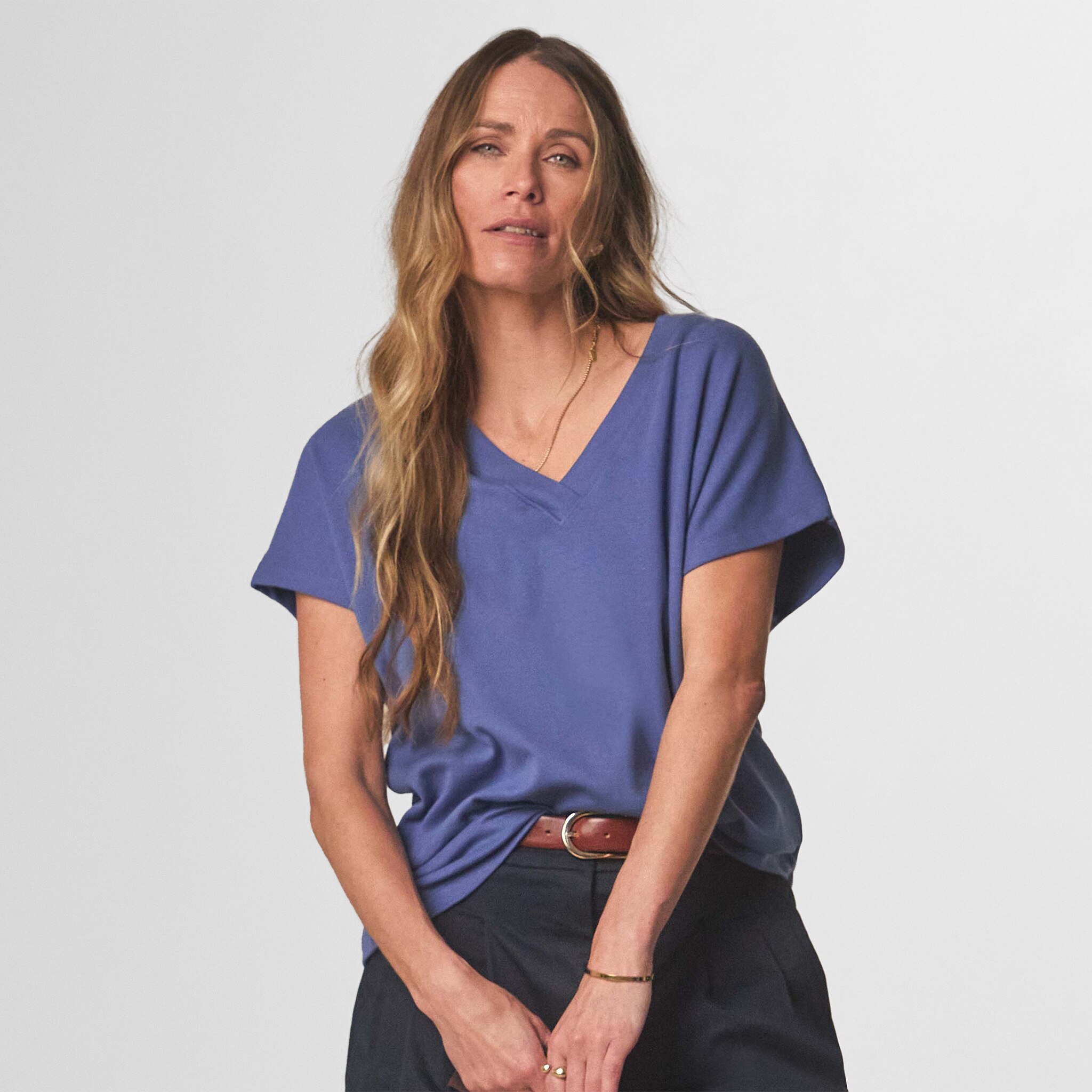 Lady wearing a blue short sleeved t-shirt.