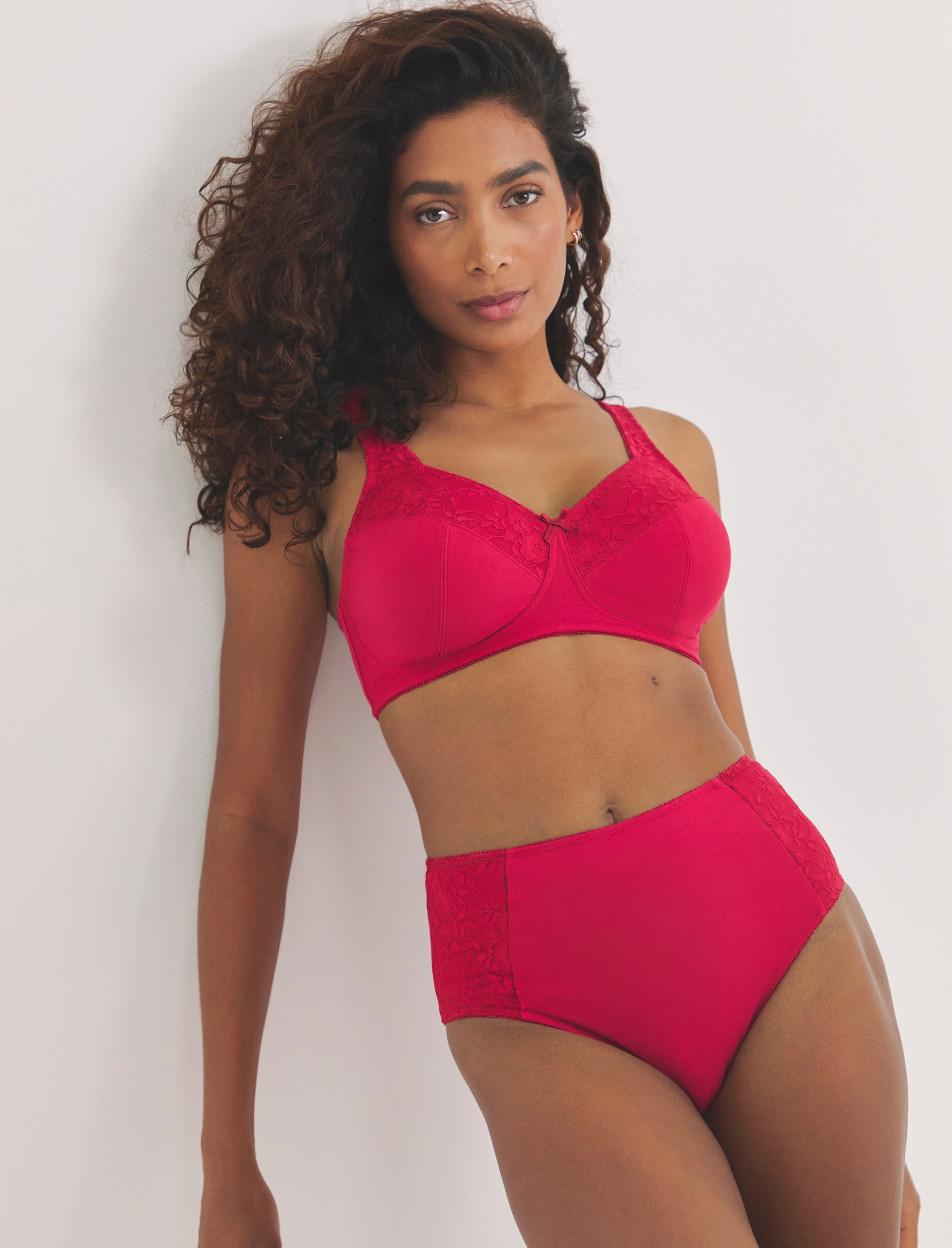 A lady wearing scarlet red matching lingerie