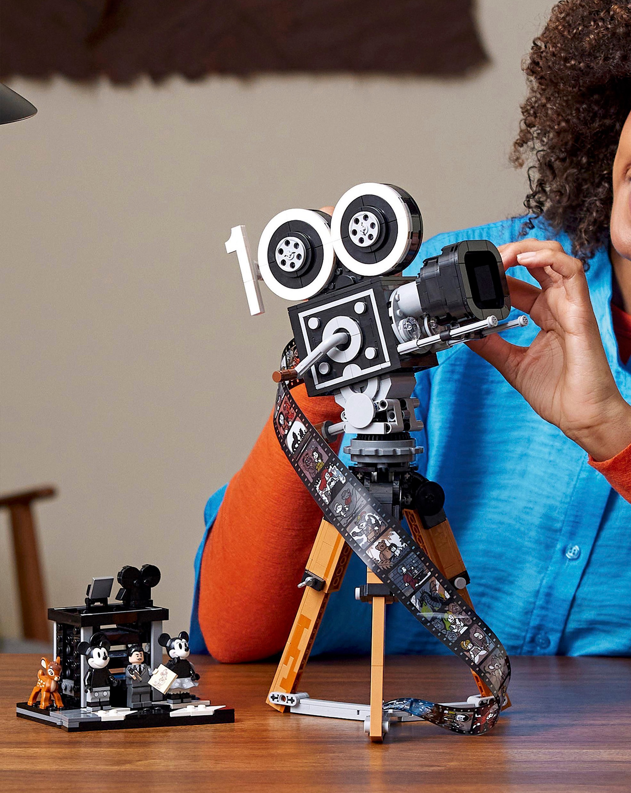 A person playing with a LEGO® Disney™ playset