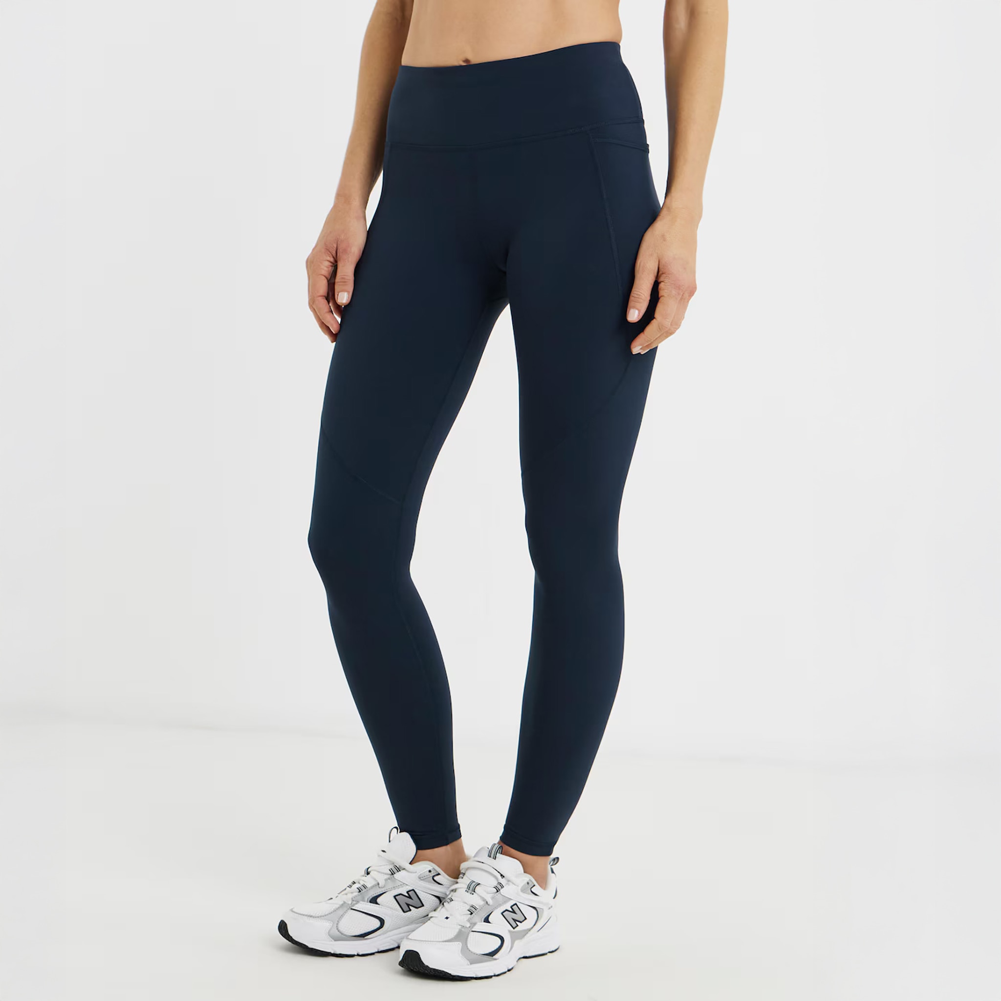 A person wearing navy blue leggings