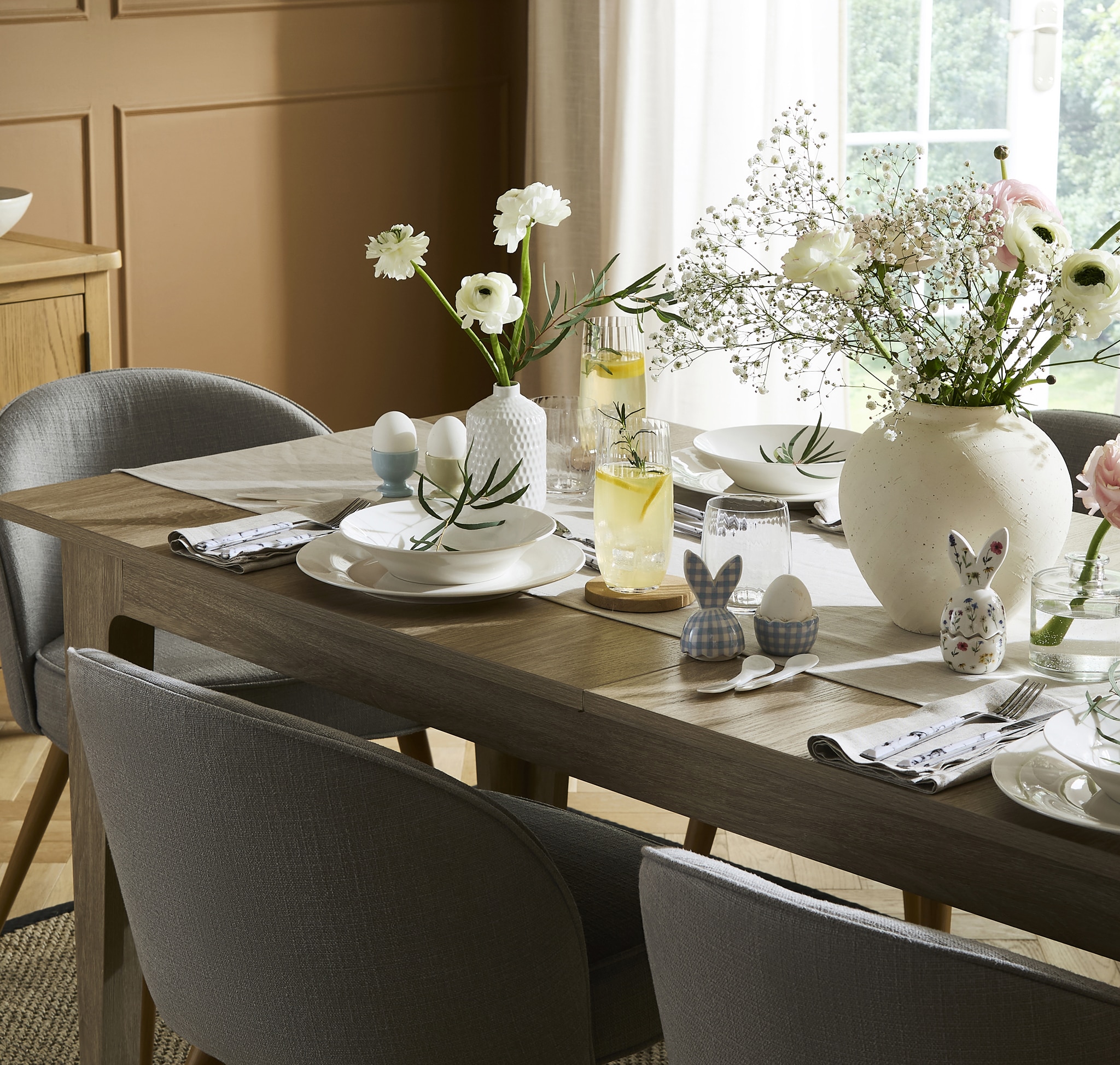 Dining table set with plates, cups and easter egg cups