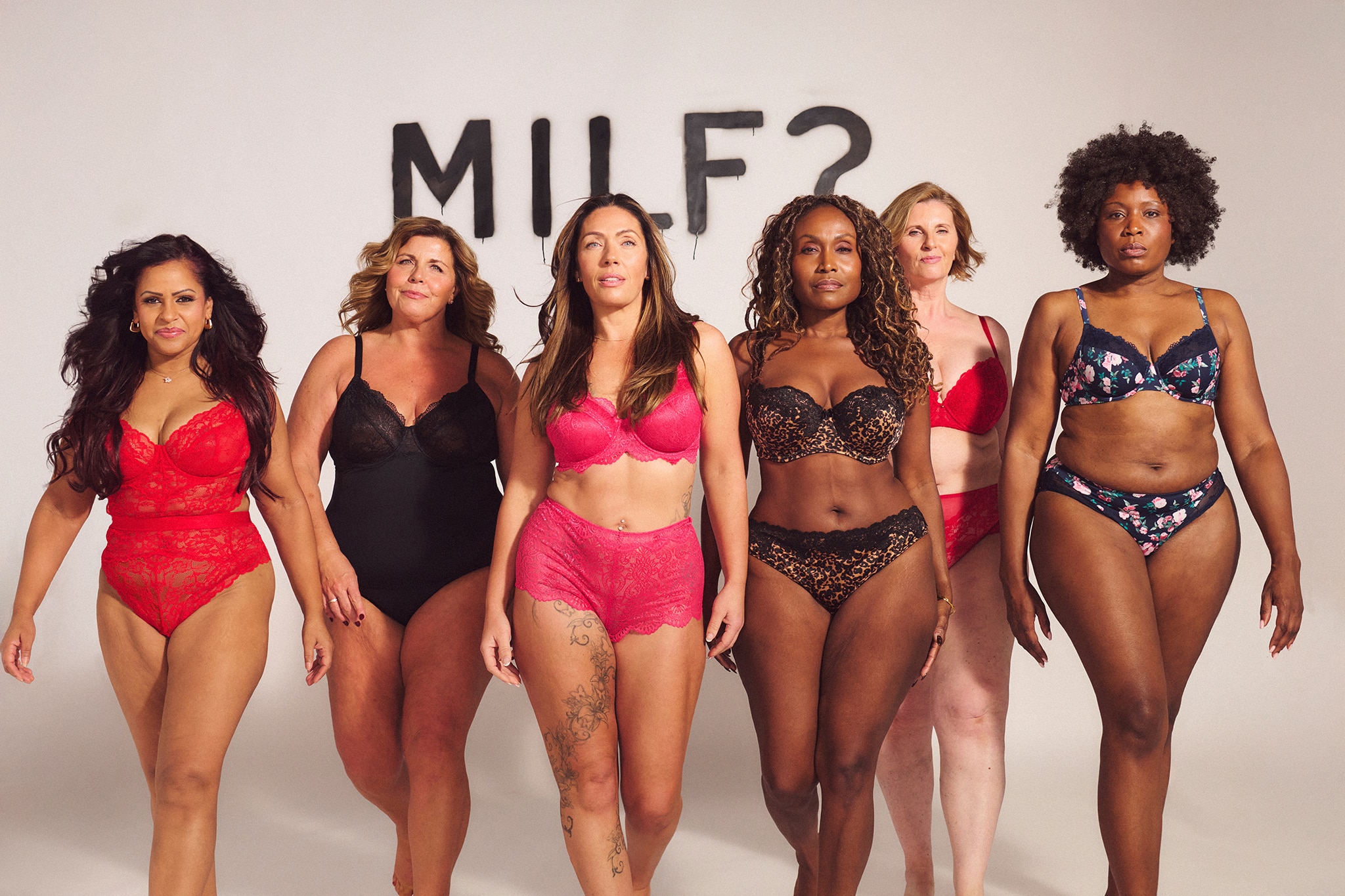 A group of ladies walking towards the camera wearing lingerie sets