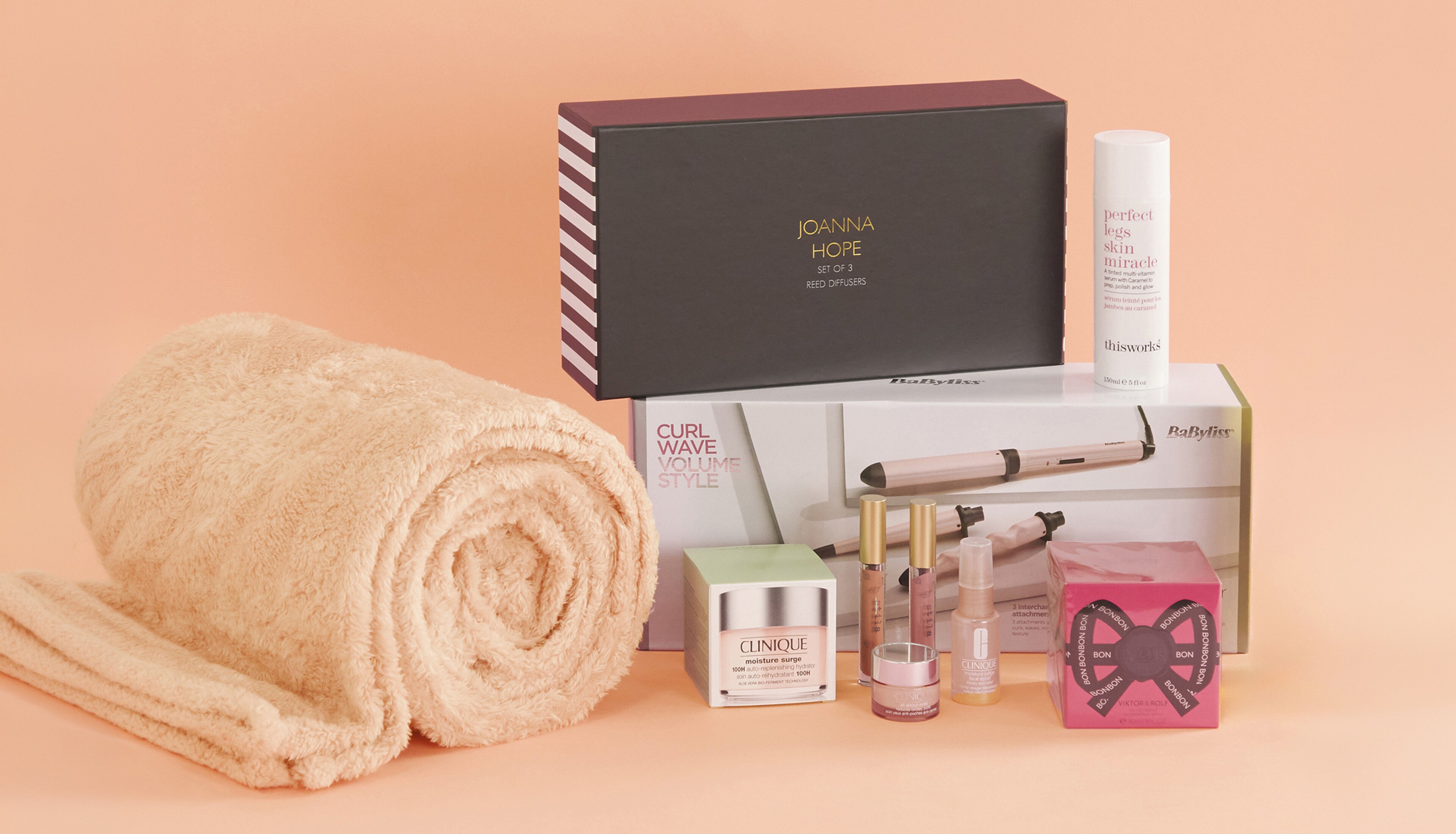 A collection of Mother's day gifts on a peach background.