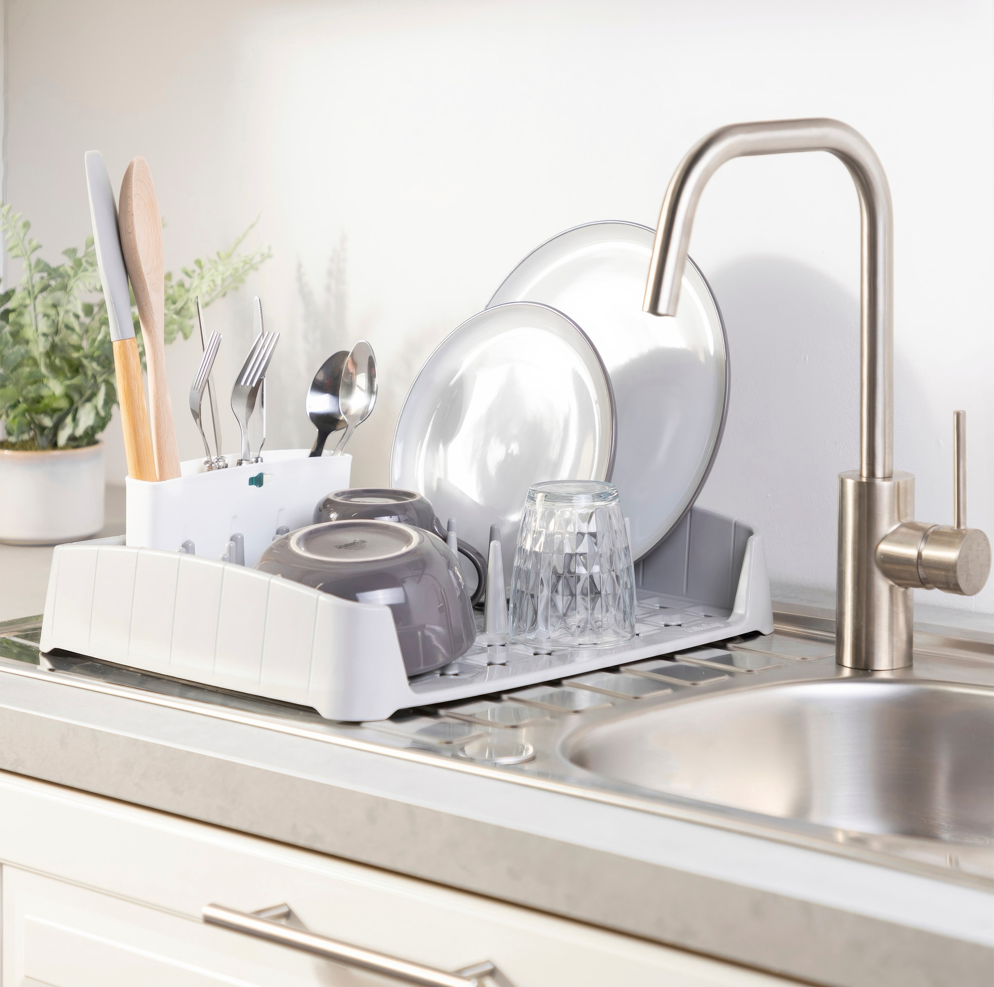 A grey kitchen sink crockery strainers