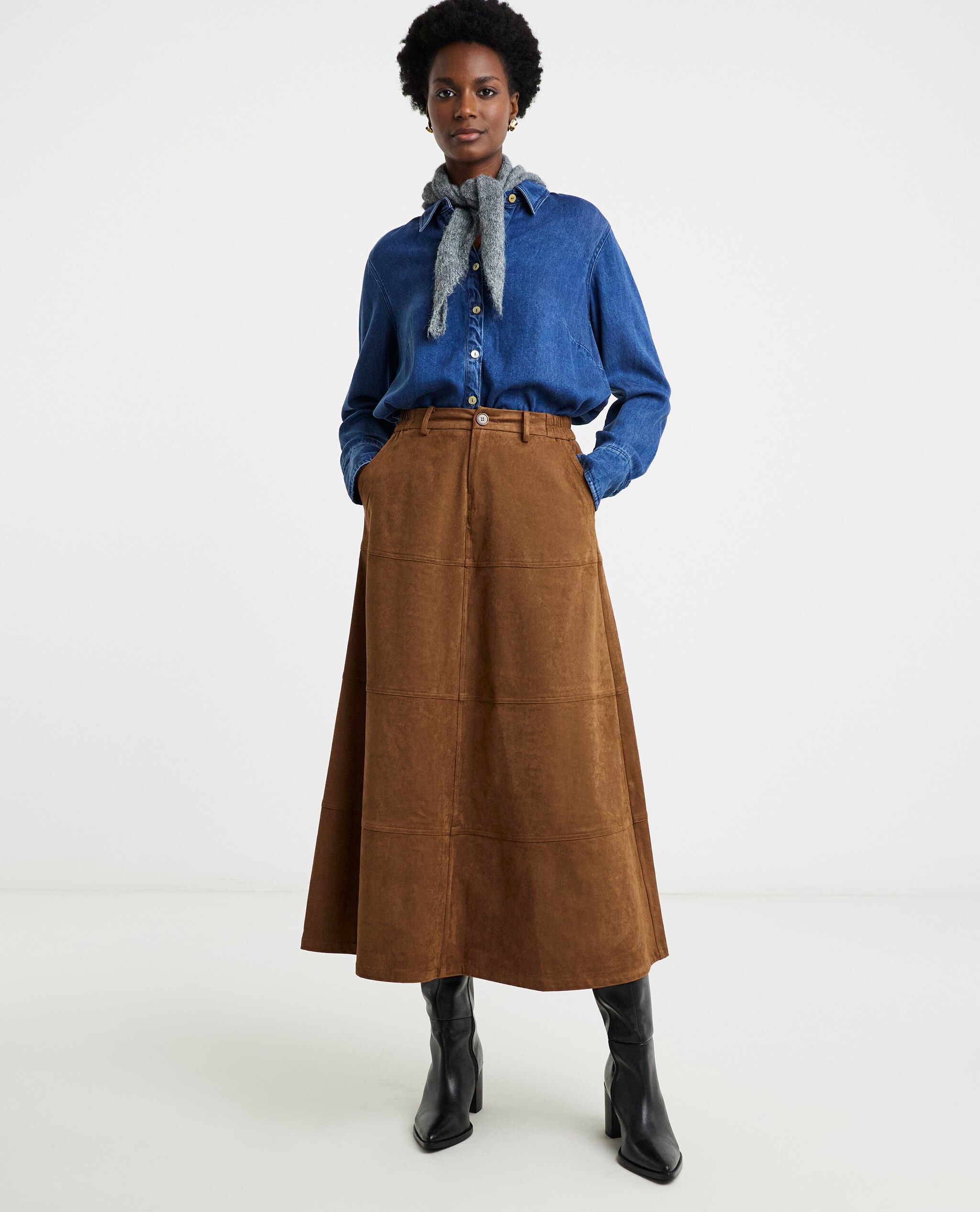 Model is wearing a suedette skirt with a blue denim shirt and neck scarf.